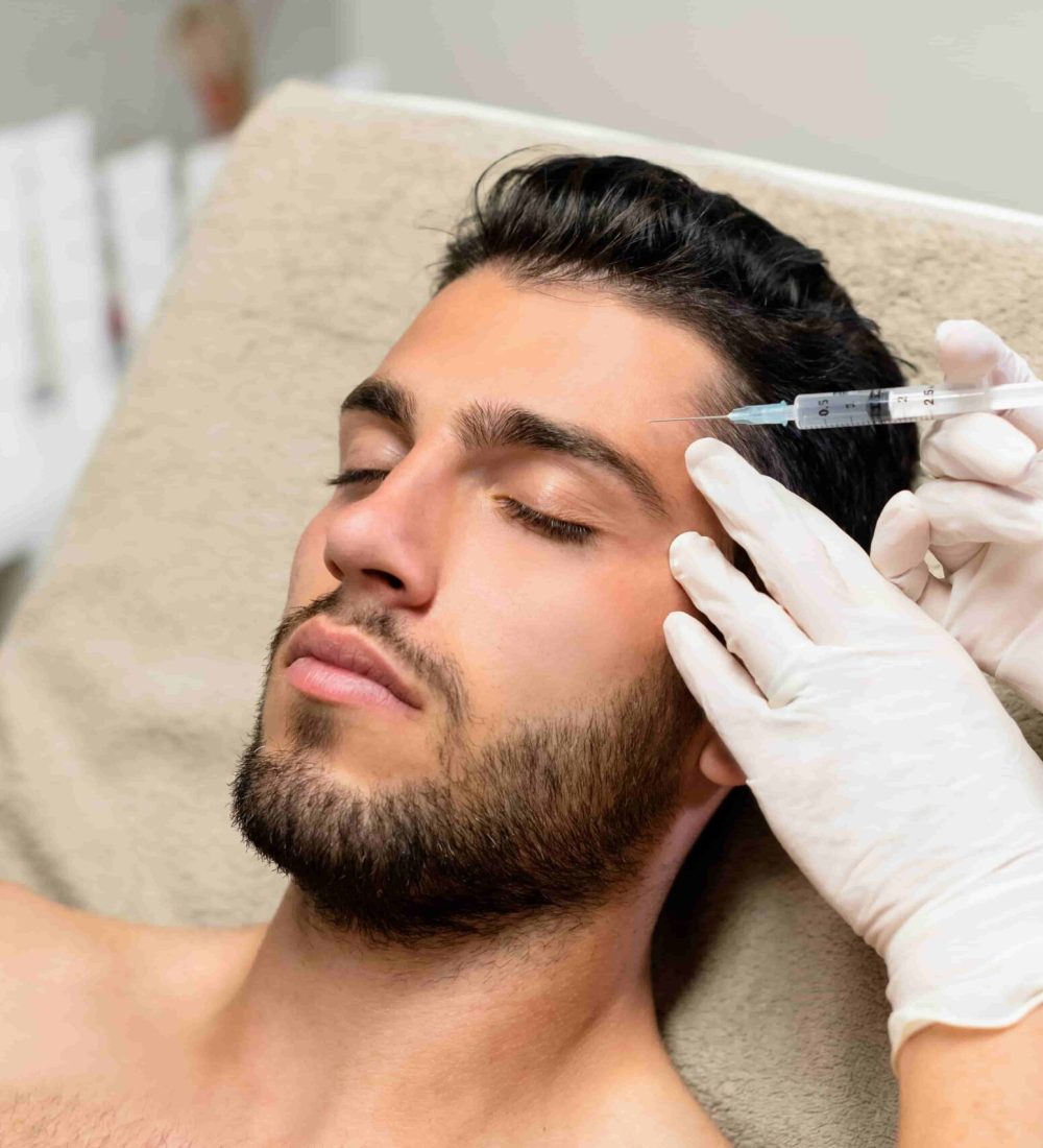 young-man-receiving-botox-injection-2023-11-27-05-18-57-utc-min